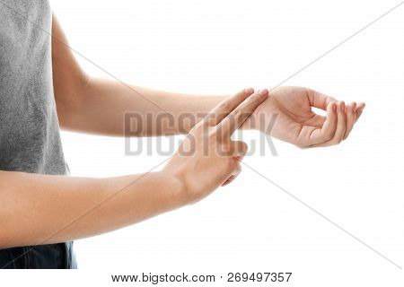 Woman Checking Pulse On Wrist Against White Background, Closeup