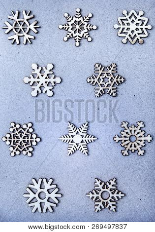 White Wooden Snowflakes On Blue Craft Paper