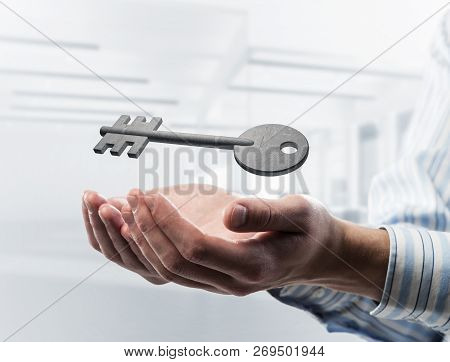 Cropped Image Of Businessman In Suit Keeping Stone Key Symbol In Hands. Mixed Media