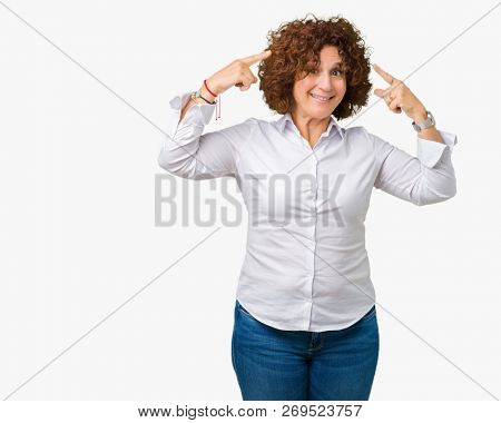 Beautiful middle ager senior businees woman over isolated background Smiling pointing to head with both hands finger, great idea or thought, good memory