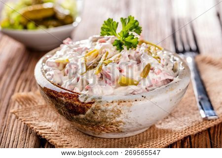 Swabian Sausage Salad - Elsasser Wurstsalat On Wooden Background.
