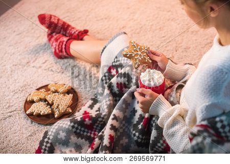 Woman In Blanked Holding Christmas Gingerbread Cookie And Cup With Hot Cocoa