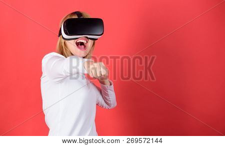 Pretty Woman Playing Game In Virtual Reality Glasses. Portrait Of An Amazed Girl Using A Virtual Rea