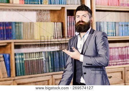 Smart Business Man Standing Near Bookcase In Vintage Librar
