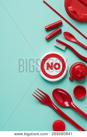 Top View Of No Sign And Disposable Plactic Wares On Blue Background