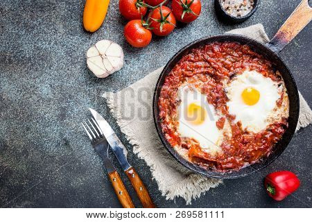 Shakshuka, Fried Eggs In Tomato Sauce In Iron Frying Pan. Typical Israel Food. Top View.