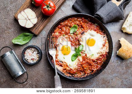 Shakshuka, Fried Eggs In Tomato Sauce In Iron Frying Pan. Typical Israel Food. Top View.