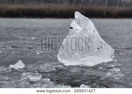 Block of ice extractad making a hole on a frozen lake. Hole frozen again.