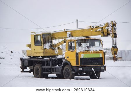 Frozen Mobile Construction Crane In The City Street In Winter.