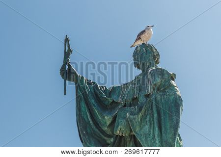 A Seagull On The Statue Of Saint Goncalo, Lagos, Portugal.ocean View, Blue Flag, Praia Azul. Praia D