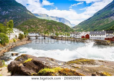 Landscape With Mountains, Houses, Bridge And River In Hellesylt, Norway.