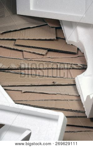 Background Image With A Lot Of Beige Cardboard Paper And Styrofoam Boxes Disgarded As Rubbish. The C