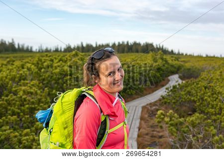 Attractive Brunette Inviting To Explore Nature With A Smile.