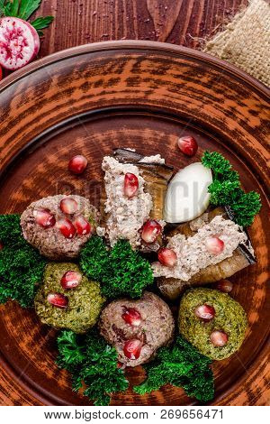 Georgian Dish - Phali Of Spinach And Meat On A Brown Plate On A Wooden Background. Close-up