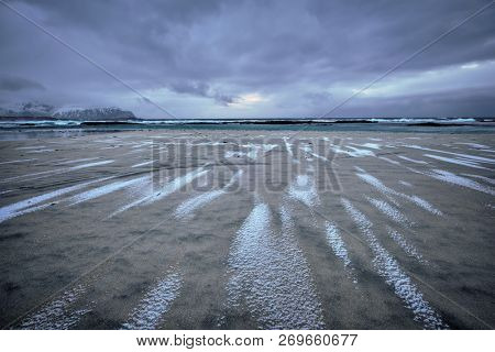 Rocky coast of fjord of Norwegian sea in winter. Skagsanden beach, Lofoten islands, Norway
