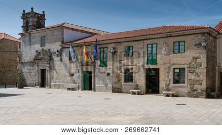 Melide, Spain - August 30, 2018: Panoramic Image Of The Town Hall In The City Center Of Melide With 