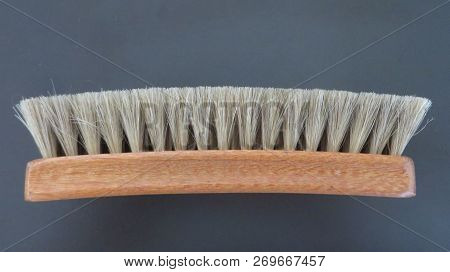 A Close-up To An Used Wooden Clothes Brush