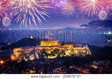 Cityscape Of Athens With Illuminated Acropolis Hill And See With Fireworks, Pathenon And Sea At Nigh
