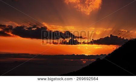 Sub Rise Behind Dark Cloud Over The Mounten
