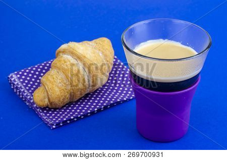 Black Coffee In Glass Cup With Croissant