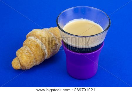Black Coffee In Glass Cup With Croissant