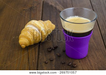 Black Coffee In Glass Cup With Croissant
