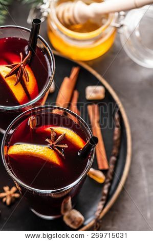 Hot Mulled Wine With Spices, Apple And Orange On Chrictmas Background. Copy Space.