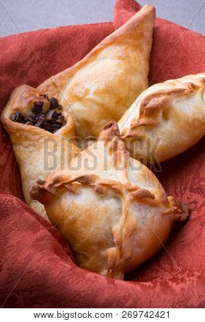 Different Baked Pirogi Or Samosa Served In A Basket