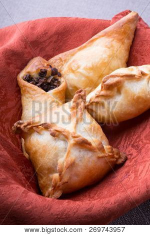 Different Baked Pirogi Or Samosa Served In A Basket