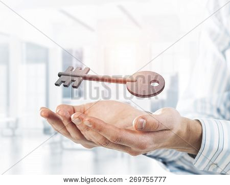 Cropped Image Of Businessman In Suit Keeping Stone Key Symbol In Hands. Mixed Media
