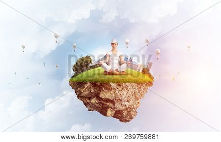 Woman In White Clothing Keeping Eyes Closed And Looking Concentrated While Meditating On Island In T