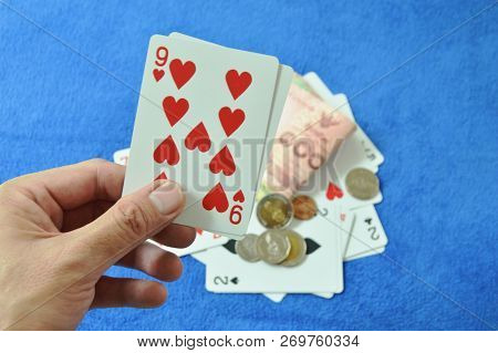 Close Up Of Hand Holding Nine Card In Baccarat Games