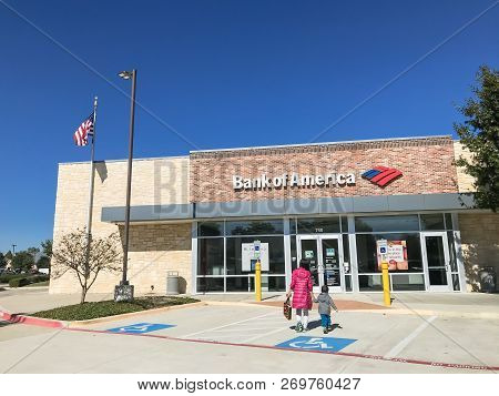 Bank Of American Branch Office With Flying American Flags And Customers Visiting