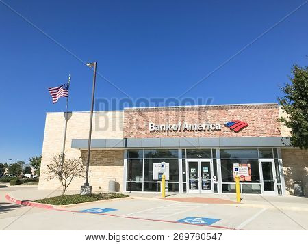 Bank Of American Branch Office With Flying American Flags And Customers Visiting