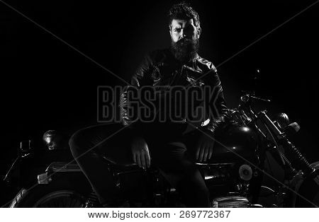 Macho, Brutal Biker In Leather Jacket Stand Near Motorcycle At Night Time, Copy Space. Biker Culture