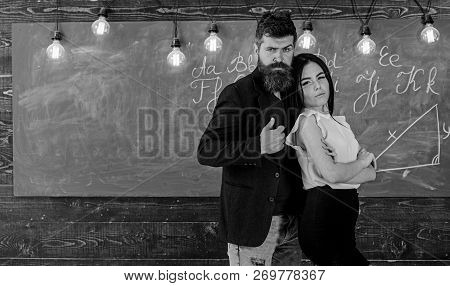 Teacher And Strict Schoolmaster Look Confident. Lady And Hipster Working Together In School. Partner