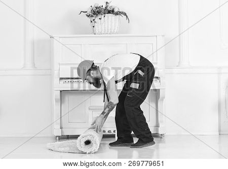 Relocating Concept. Courier Delivers Furniture In Case Of Move Out, Relocation. Man With Beard, Work