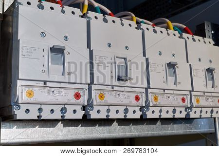 Four Power Circuit Breakers Are Fixed In The Electrical Cabinet In Line. Modern And Reliable Switche