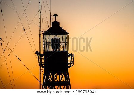 Abstract Photo With Industrial Character Of A Lighthouse Against A Brightly Colored Sky With Beautif