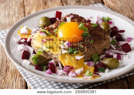 Traditional Danish Steak Pariserbof With Egg Yolk And Mustard, Served With Onions, Capers And Beet C