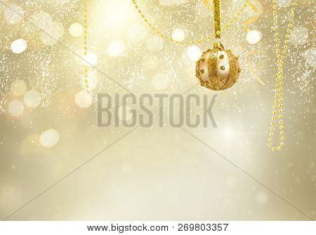 Golden Christmas Balls Garland On Glowing And Shiny Golden Background With Copy Space
