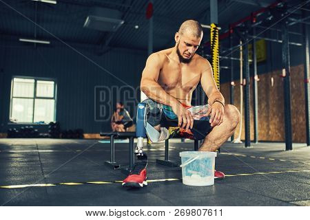 Sportsman With Prosthesis Working Out In Gym