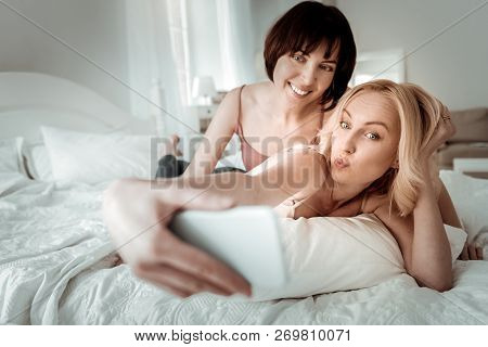 Joyful Girls Posing While Taking Funny Selfie