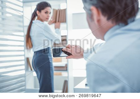 Workman Photographing His Secretary Without Her Permission
