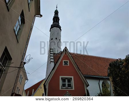 Tower Of The Church Of The Holy Spirit With Red House In Tallinn, Estonia