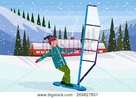 Man Windboarding Windsurfing On Snow Over Small Village Houses Winter Snowy Mountains Hills Fir Tree