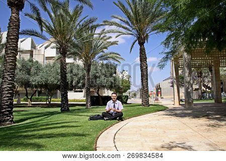 Beer Sheva,  Israel - June 11, 2011:  Man Sits On The Lawn In University Campus In Beer Sheva