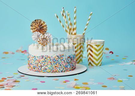 Delicious Cake, Plactic Cups And Drinking Straws On Blue Background With Confetti