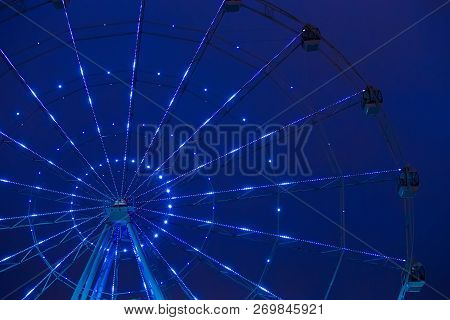 Carnival Ride Showing A Spinning Ferris Wheel In Action- Long Exposure Shot.