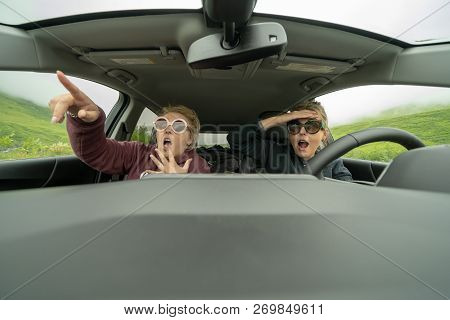 Two Woman Inside Of A Car Looked Shocked, Scared And Astounished As They Are Driving